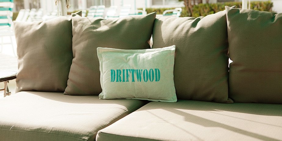 Close-up of pillow on sofa in covered area by the pool