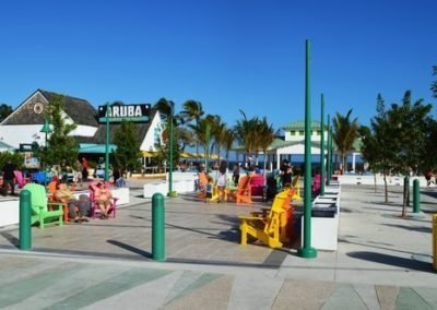 Photo of pier from the street with Aruba restaurant in background.